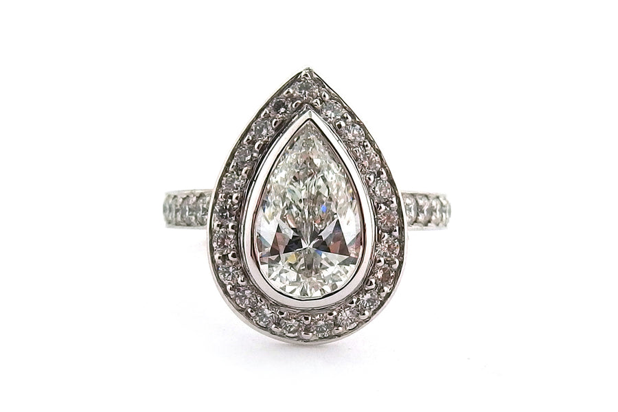 18ct white gold bezel set pear shape diamond halo ring with diamonds on the band