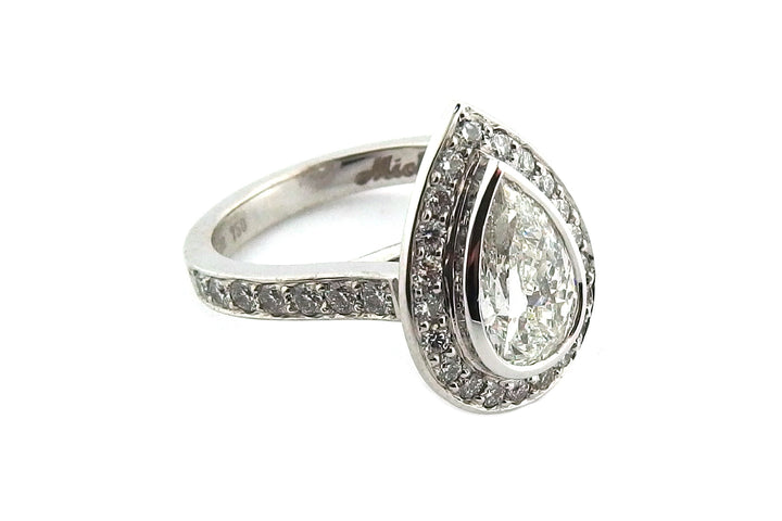 18ct white gold bezel set pear shape diamond halo ring with diamonds on the band