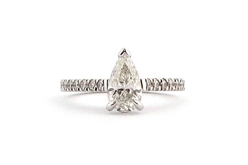 18ct white gold claw set pear shape ring with diamonds on the band