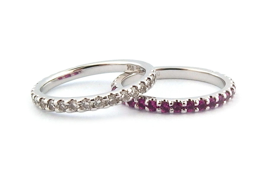 18ct white gold diamond set wedding ring and a matching eternity ring set with pink sapphires