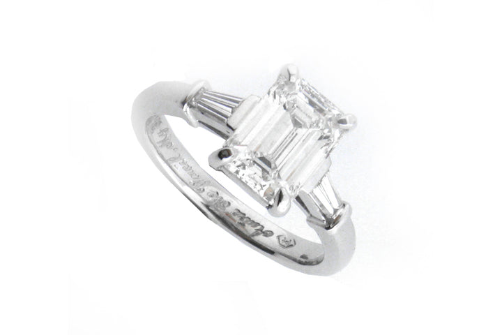 Platinum ring with a four claw set emerald cut diamond and tapered baguettes