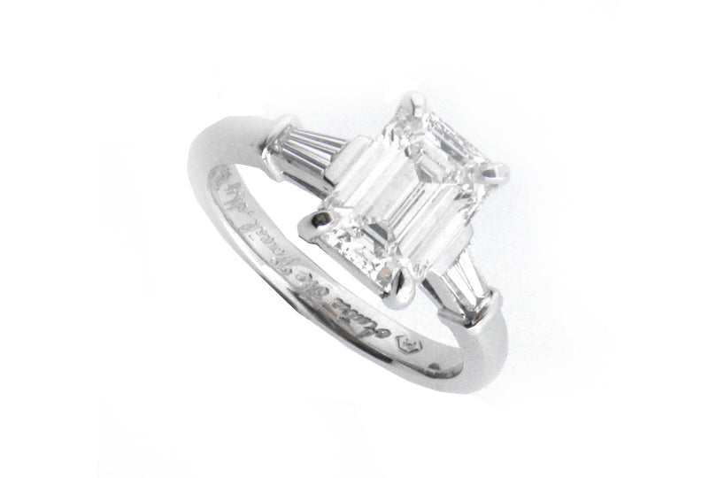 Platinum ring with a four claw set emerald cut diamond and tapered baguettes