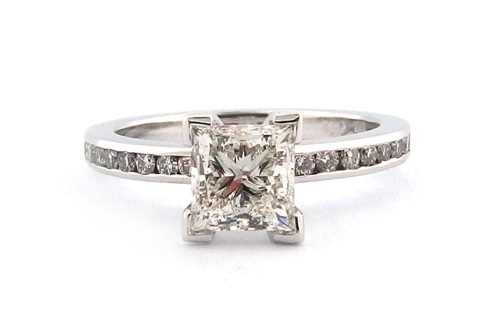 18ct white gold four corner set princess cut diamond with channel set diamonds on the band