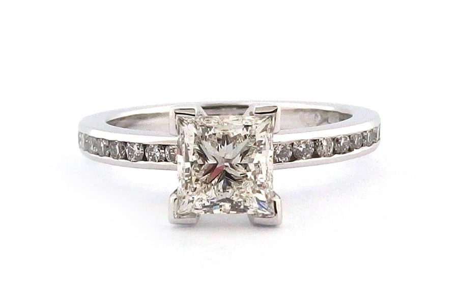 18ct white gold four corner set princess cut diamond with channel set diamonds on the band