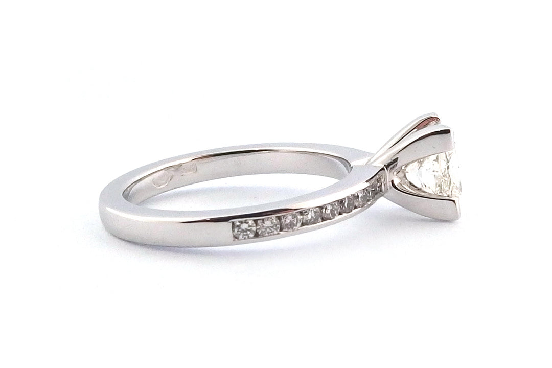 18ct white gold four corner set princess cut diamond with channel set diamonds on the band