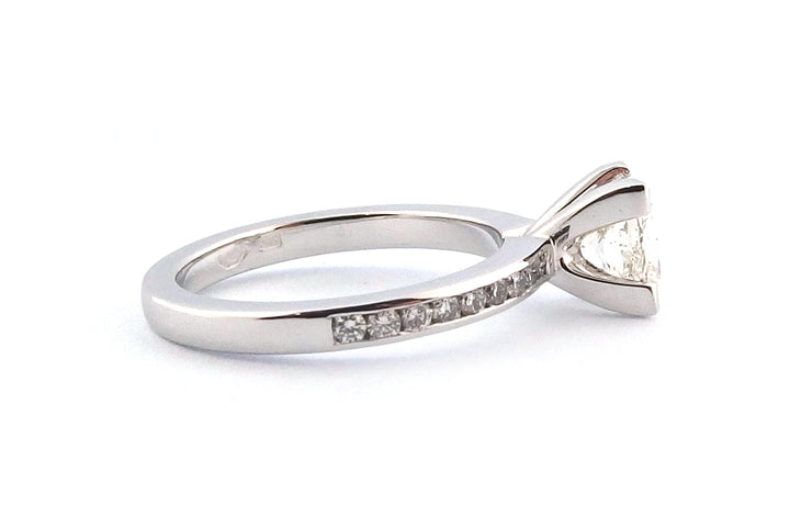 18ct white gold four corner set princess cut diamond with channel set diamonds on the band