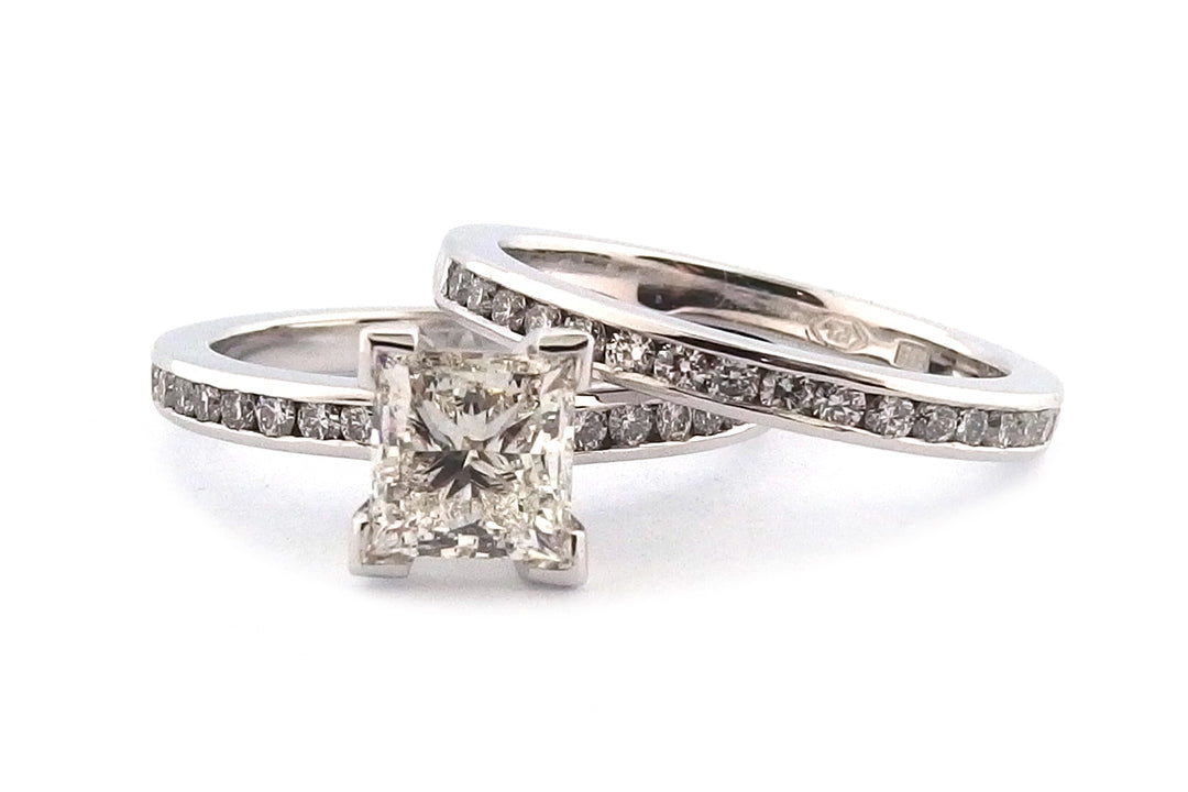18ct white gold four corner set princess cut diamond with channel set diamonds on the band