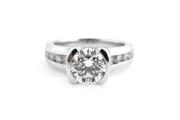 Half Bezel set round brilliant cut diamond ring with channel set diamonds