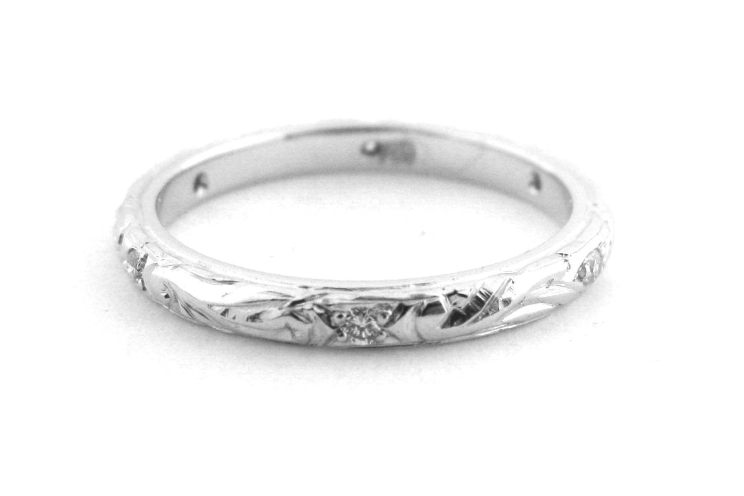 Ladies wedding band with engraving and hammer set diamonds
