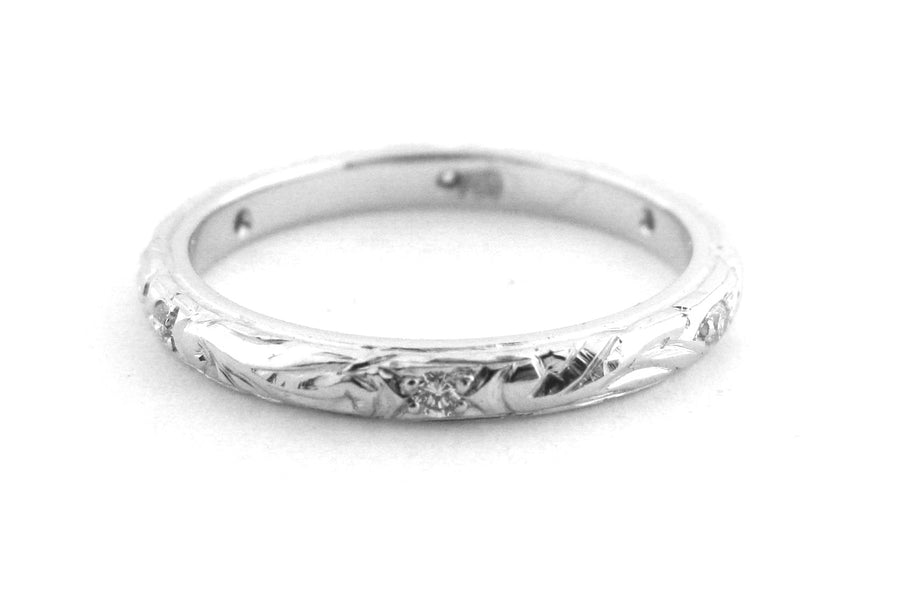 Ladies wedding band with engraving and hammer set diamonds