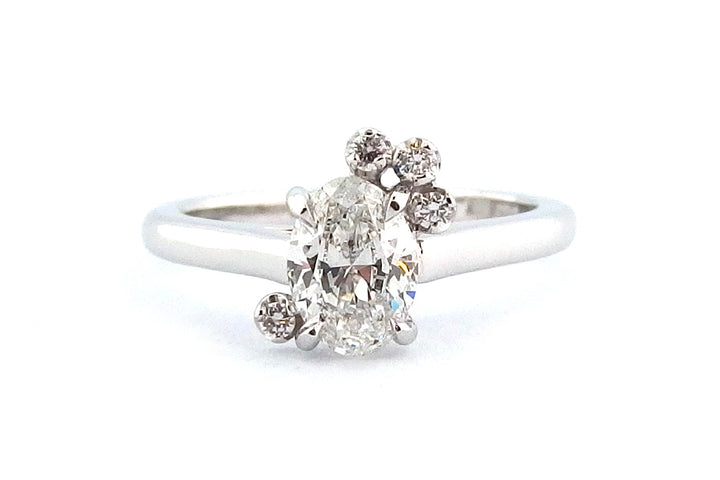 18ct white gold oval diamond with a small cluster of round diamonds