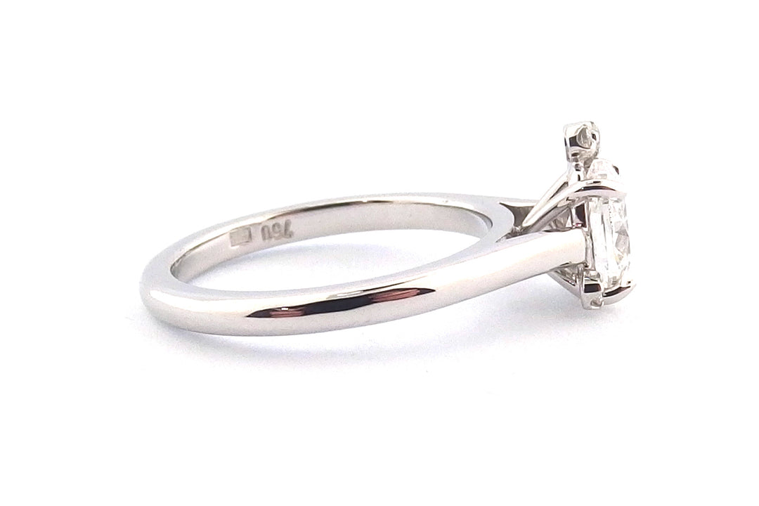 18ct white gold oval diamond with a small cluster of round diamonds