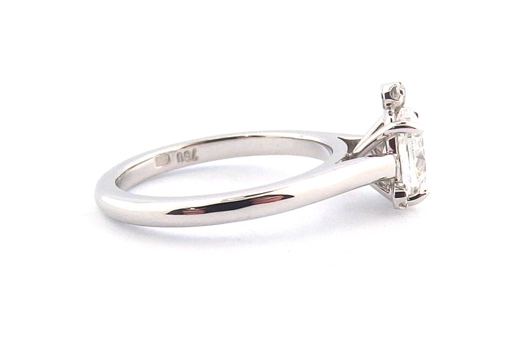 18ct white gold oval diamond with a small cluster of round diamonds