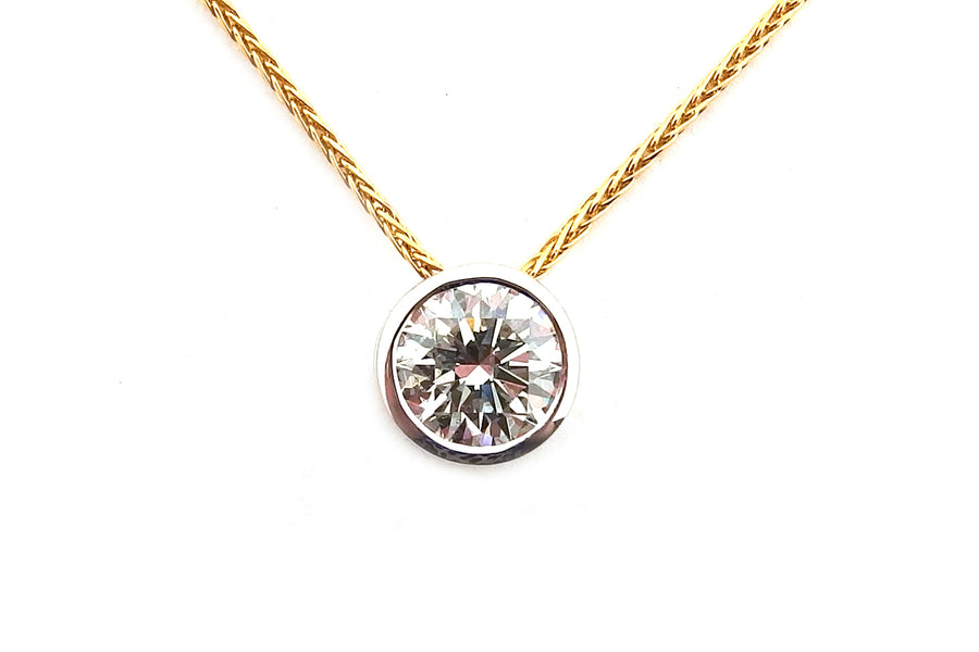 18ct white gold round brilliant cut bezel set pendant with an 18ct yellow gold chain