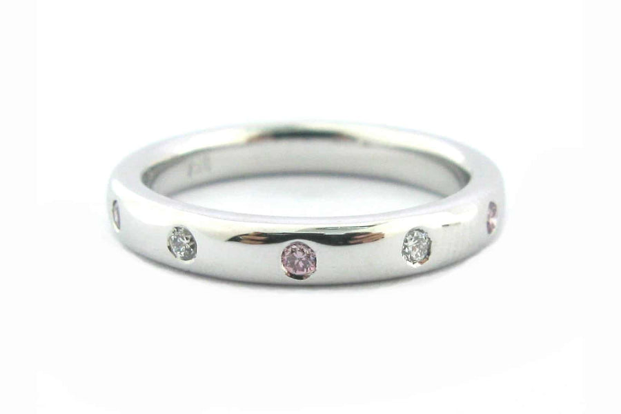 Ladies wedding ring with pink and white diamonds hammer set