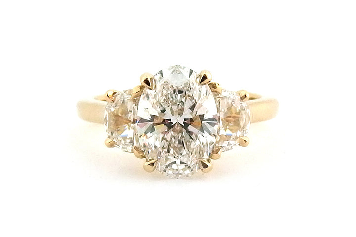18ct yellow gold three stone ring with an oval and two half moon shape diamonds