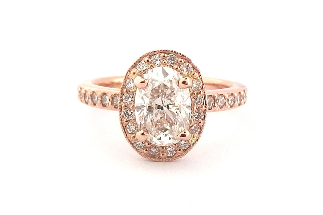 18ct rose gold halo ring, set with an oval diamond and bead set diamonds on the band