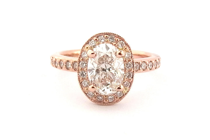 18ct rose gold halo ring, set with an oval diamond and bead set diamonds on the band