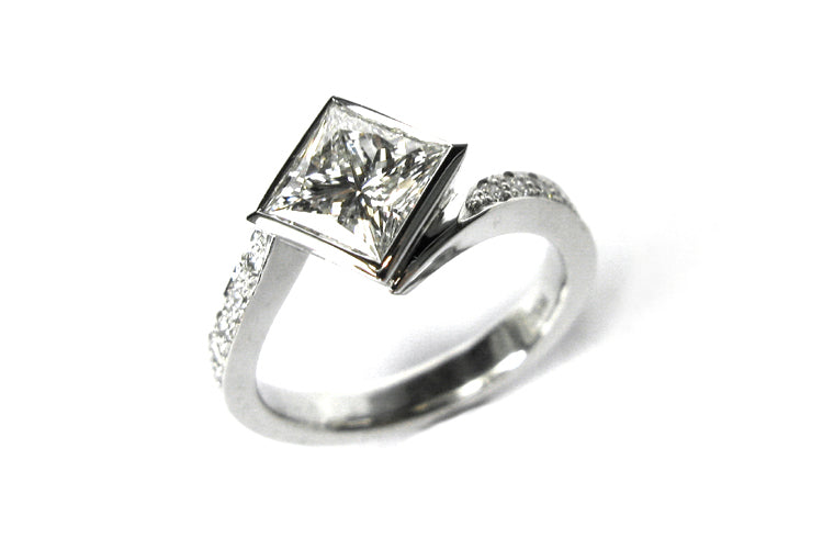 Bezel set princess cut diamond ring with a twisted band