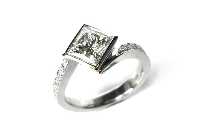Bezel set princess cut diamond ring with a twisted band