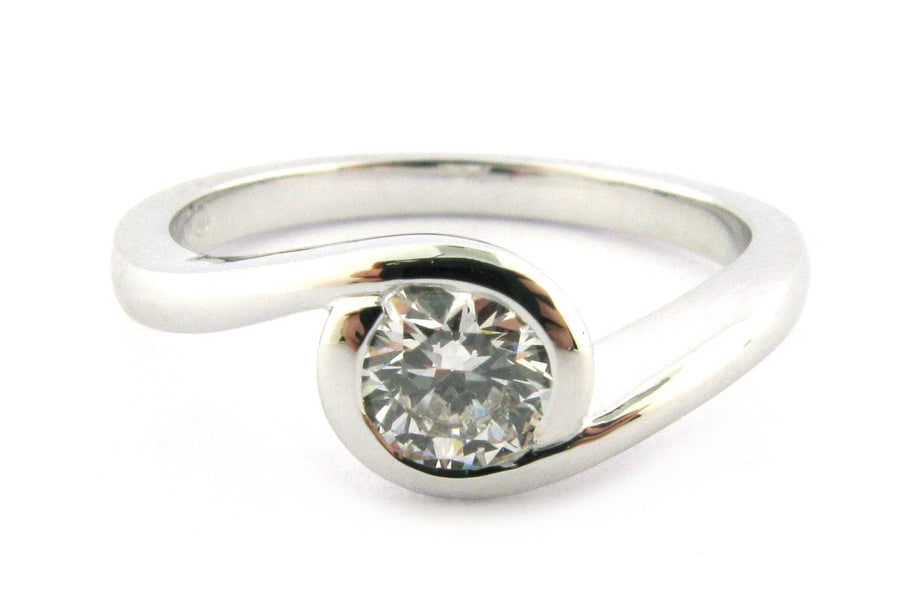 Bezel set round brilliant cut diamond ring with a twisted band