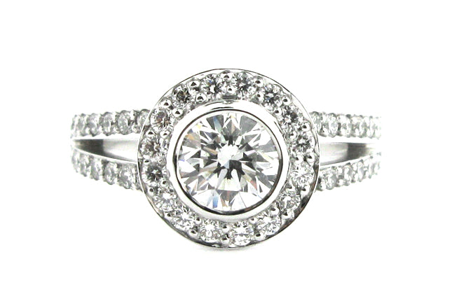 Bezel set round brilliant cut diamond halo ring with a split band