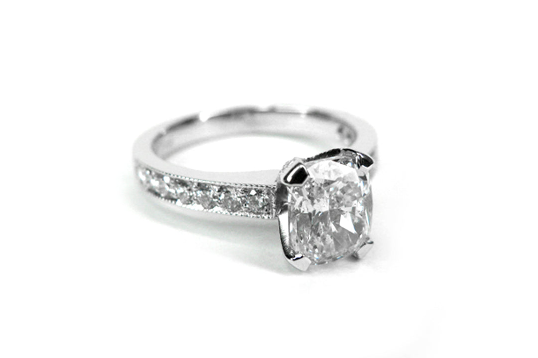 Cushion cut ring with bead set diamonds