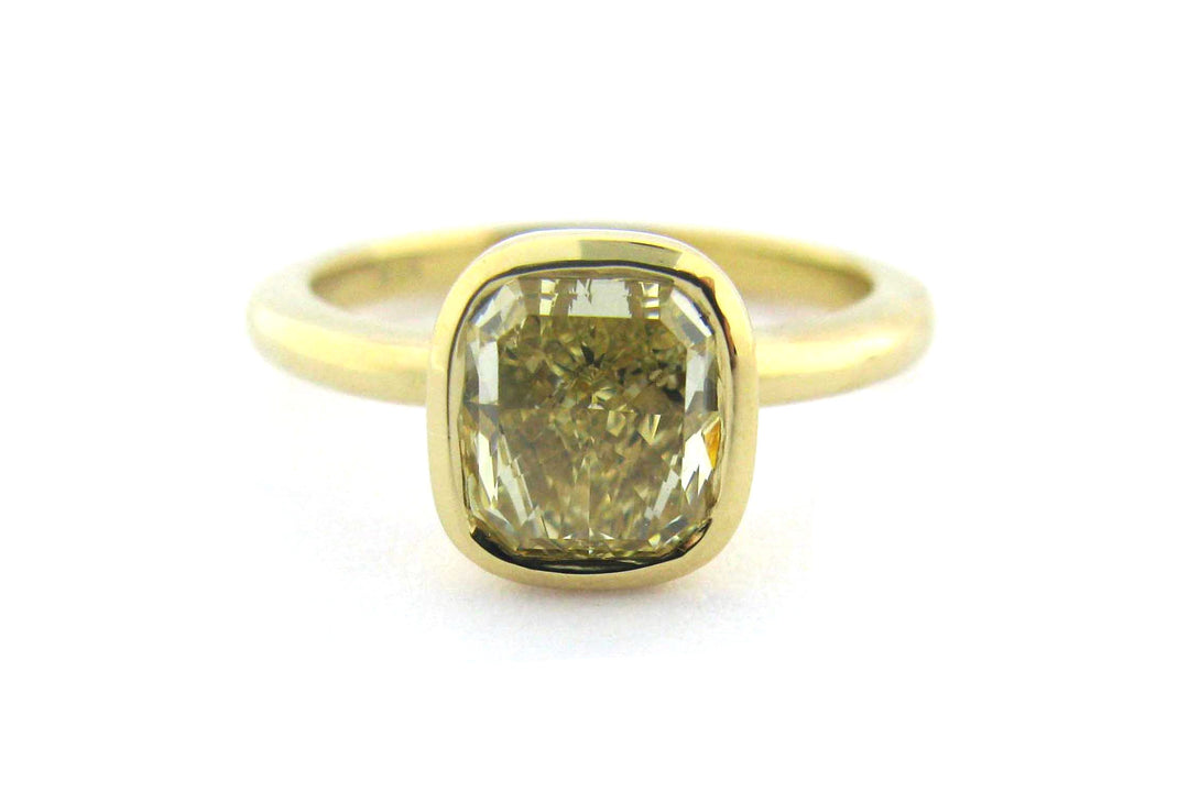 Bezel set yellow cushion cut diamond ring