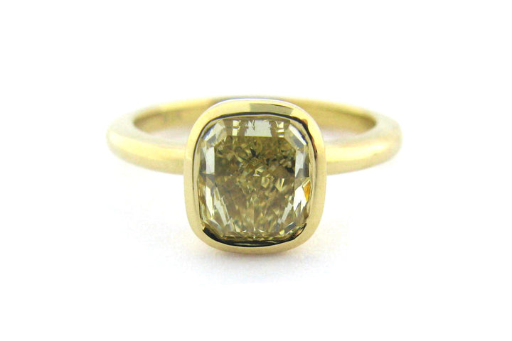 Bezel set yellow cushion cut diamond ring