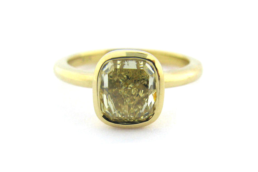 Bezel set yellow cushion cut diamond ring