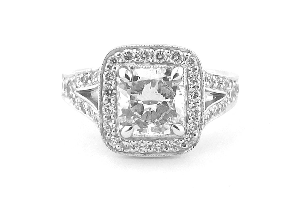 Halo ring with a spit band and a milgrain edge