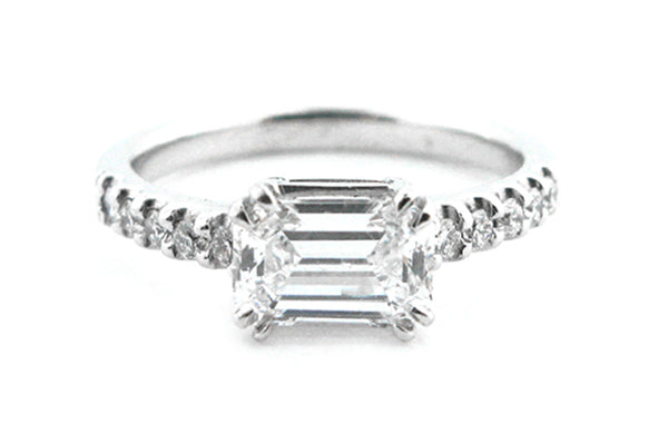 Horizontal emerald cut with claw set diamonds