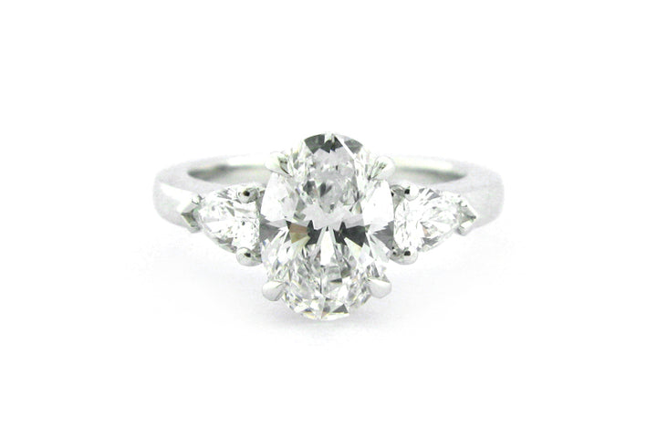 Oval and pear shape diamond three stone ring