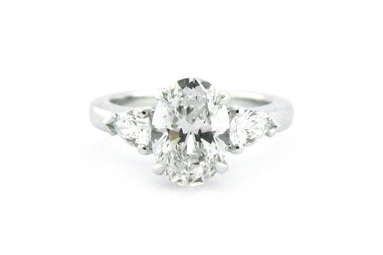 Oval and pear shape diamond three stone ring