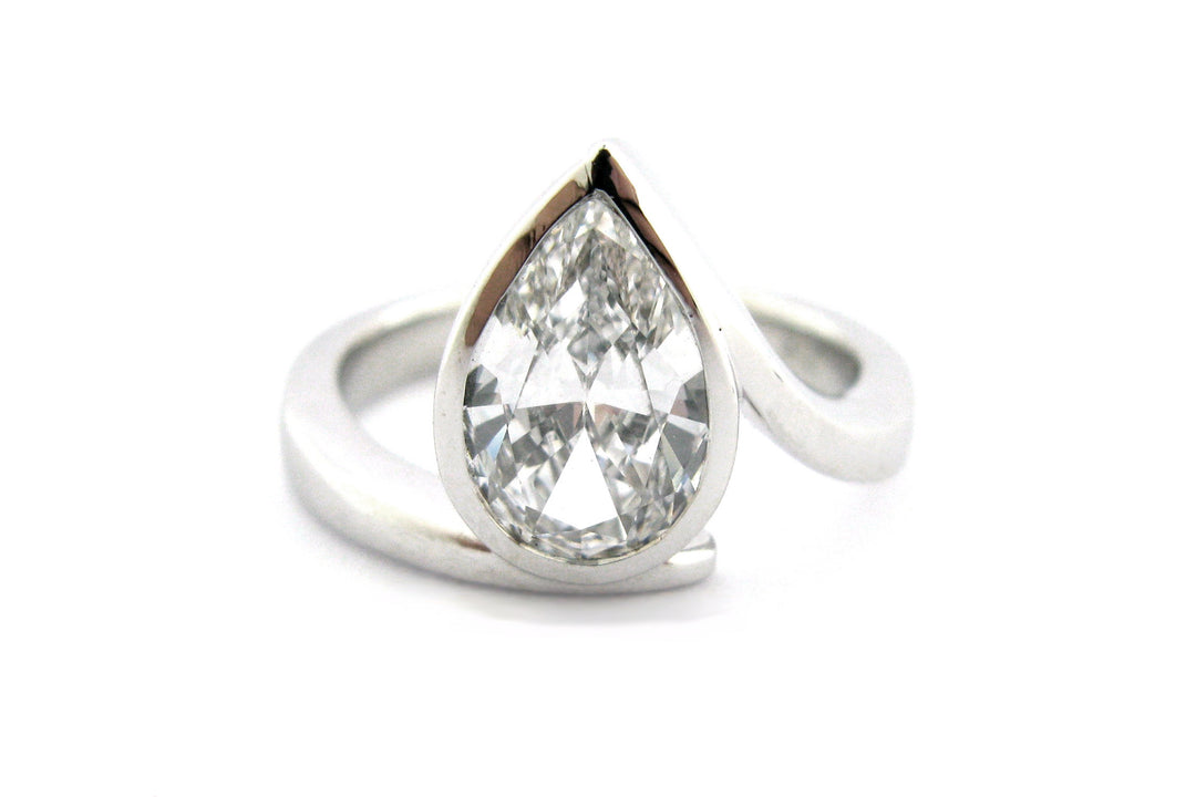 Pear shape diamond ring with a twisted band