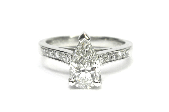 Pear shape diamond ring with bead set diamonds on the band