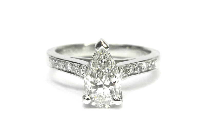 Pear shape diamond ring with bead set diamonds on the band
