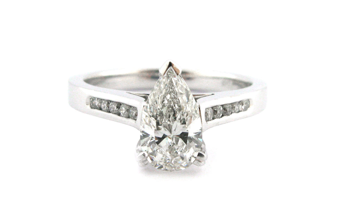 Pear shape diamond ring with channel set diamonds