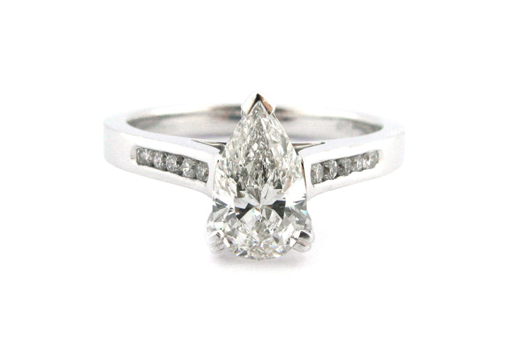 Pear shape diamond ring with channel set diamonds