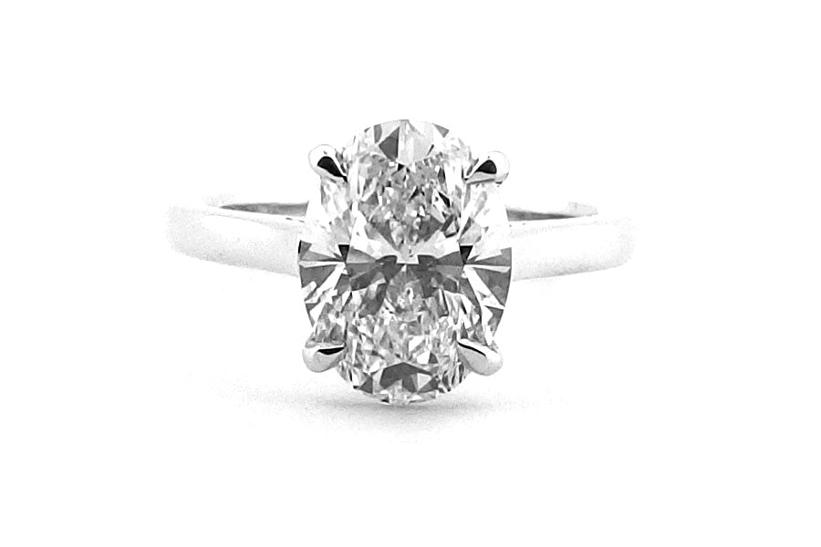 Platinum oval diamond ring with a fine four claw setting