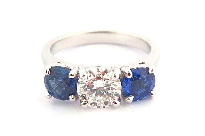 Platinum sapphire and diamond claw set three stone ring