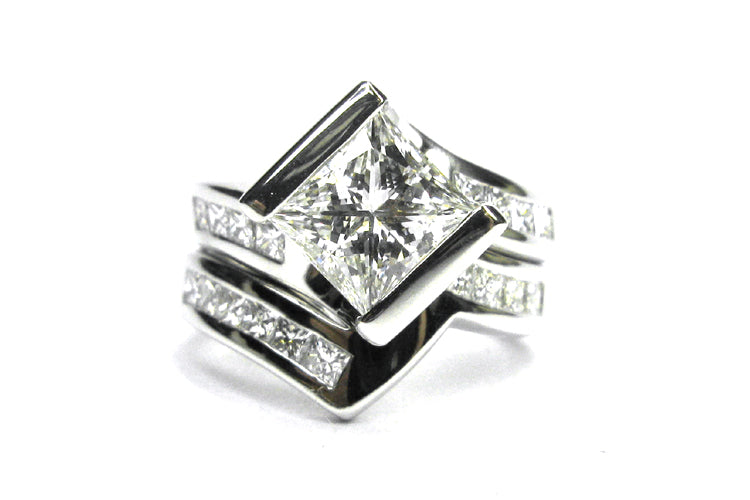 Princess cut diamond ring set on the diagonal with a twisted band and matching wedding band