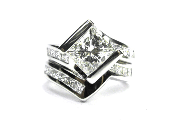 Princess cut diamond ring set on the diagonal with a twisted band and matching wedding band