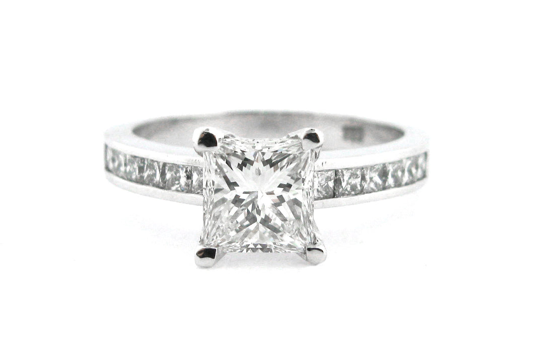 Princess cut diamond ring with channel set diamonds in the band
