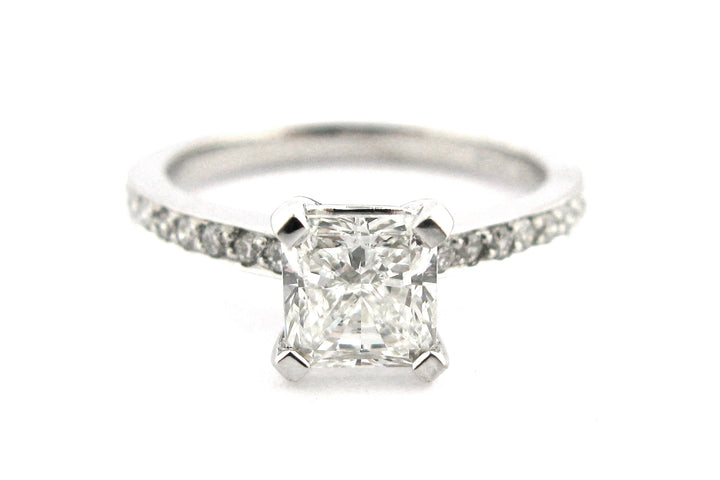 Radiant cut diamond ring with a bead set band