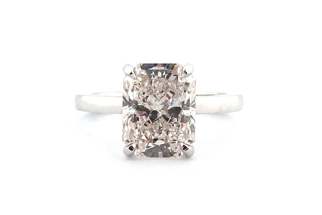 Radiant cut four claw ring
