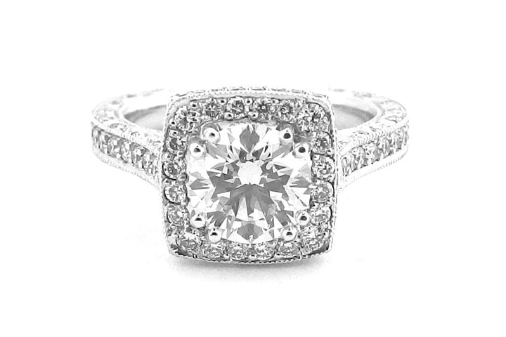 Round brilliant cut diamond ring set with double claws and a halo of diamonds