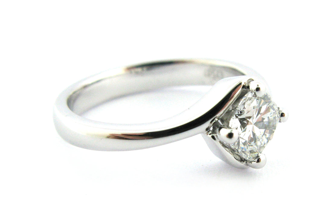 Twisted ring with a cushion cut diamond claw set