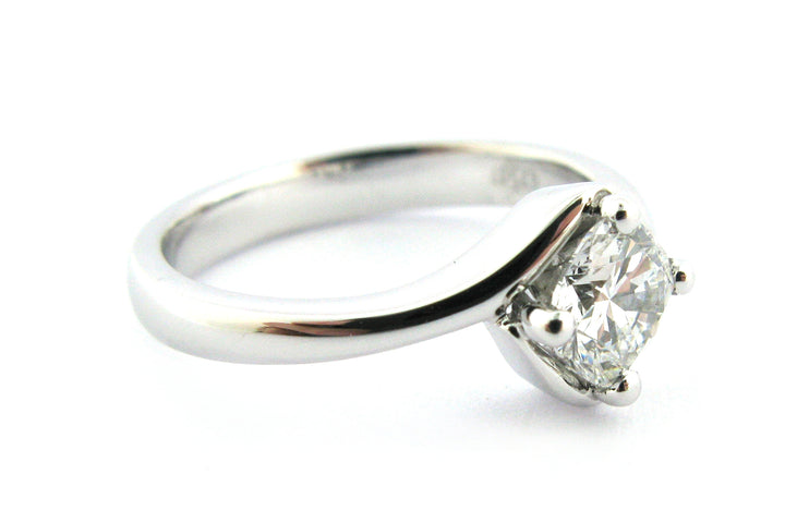 Twisted ring with a cushion cut diamond claw set