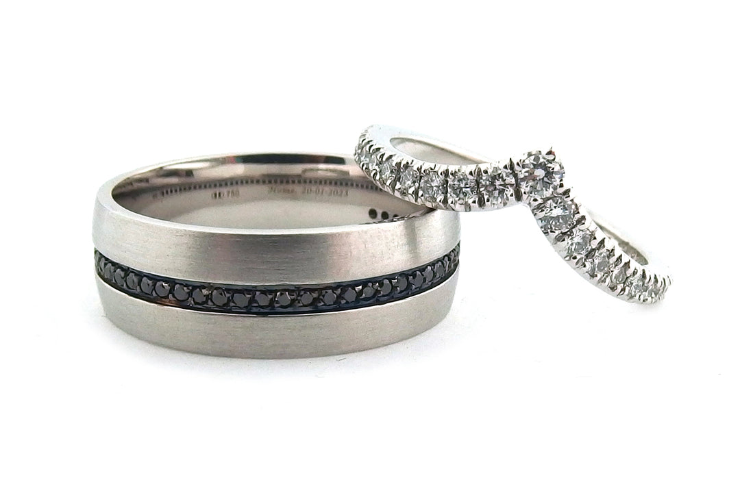 White gold mens wedding band with treated black diamonds and a womans 'V' shape diamond set wedding band